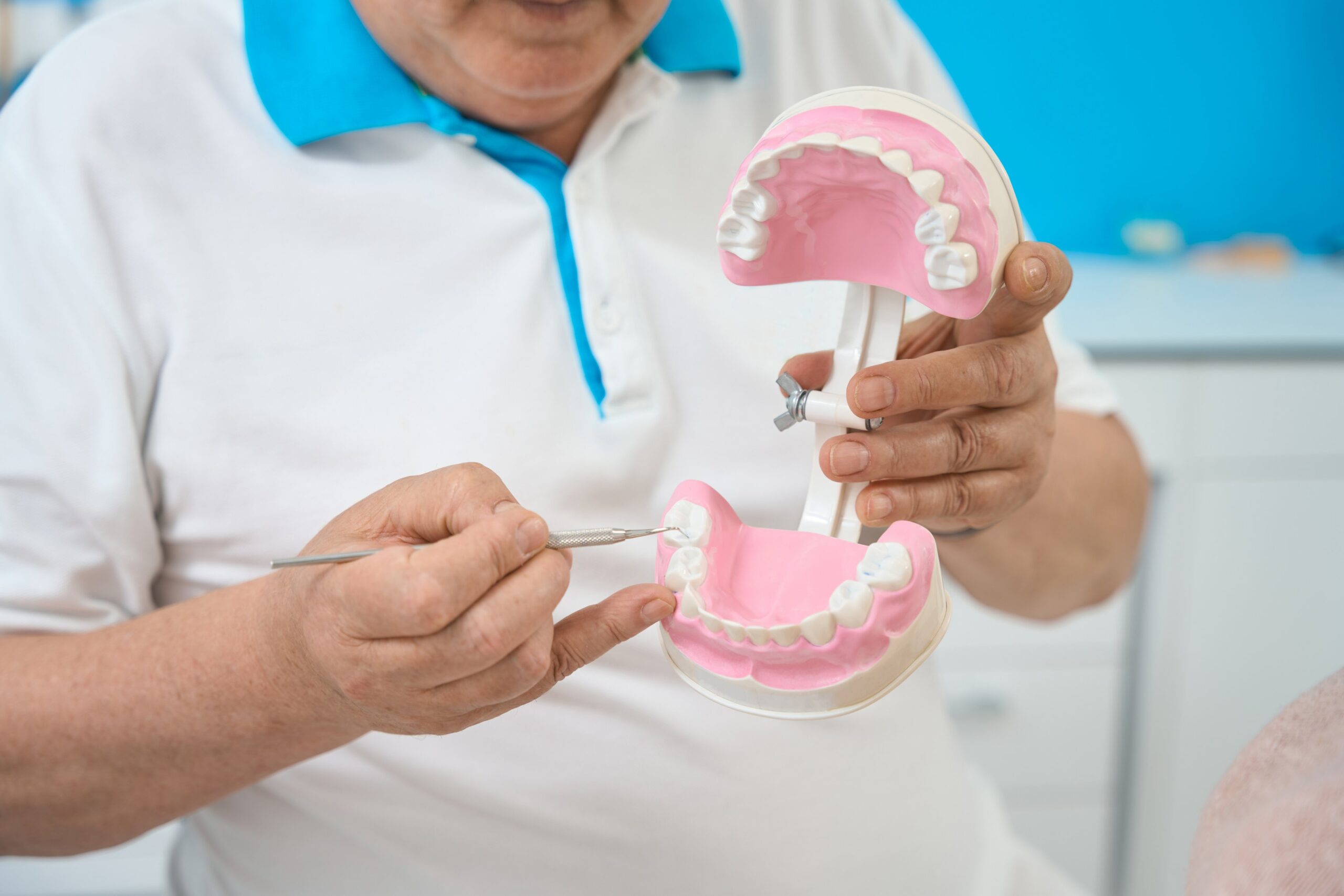 orthodontist-with-artificial-jaw-working-in-his-de-2024-10-18-09-31-40-utc