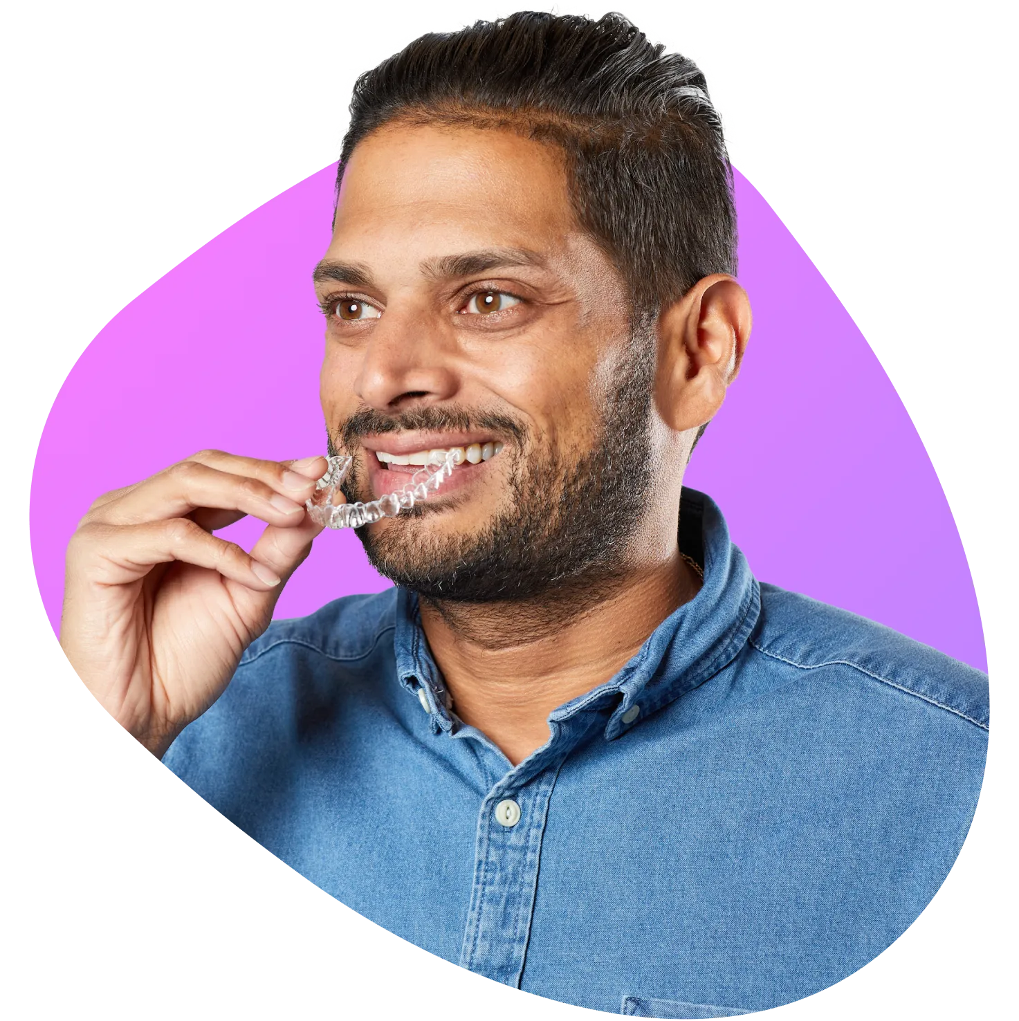 SureSmile clear aligner candidate holding an aligner tray