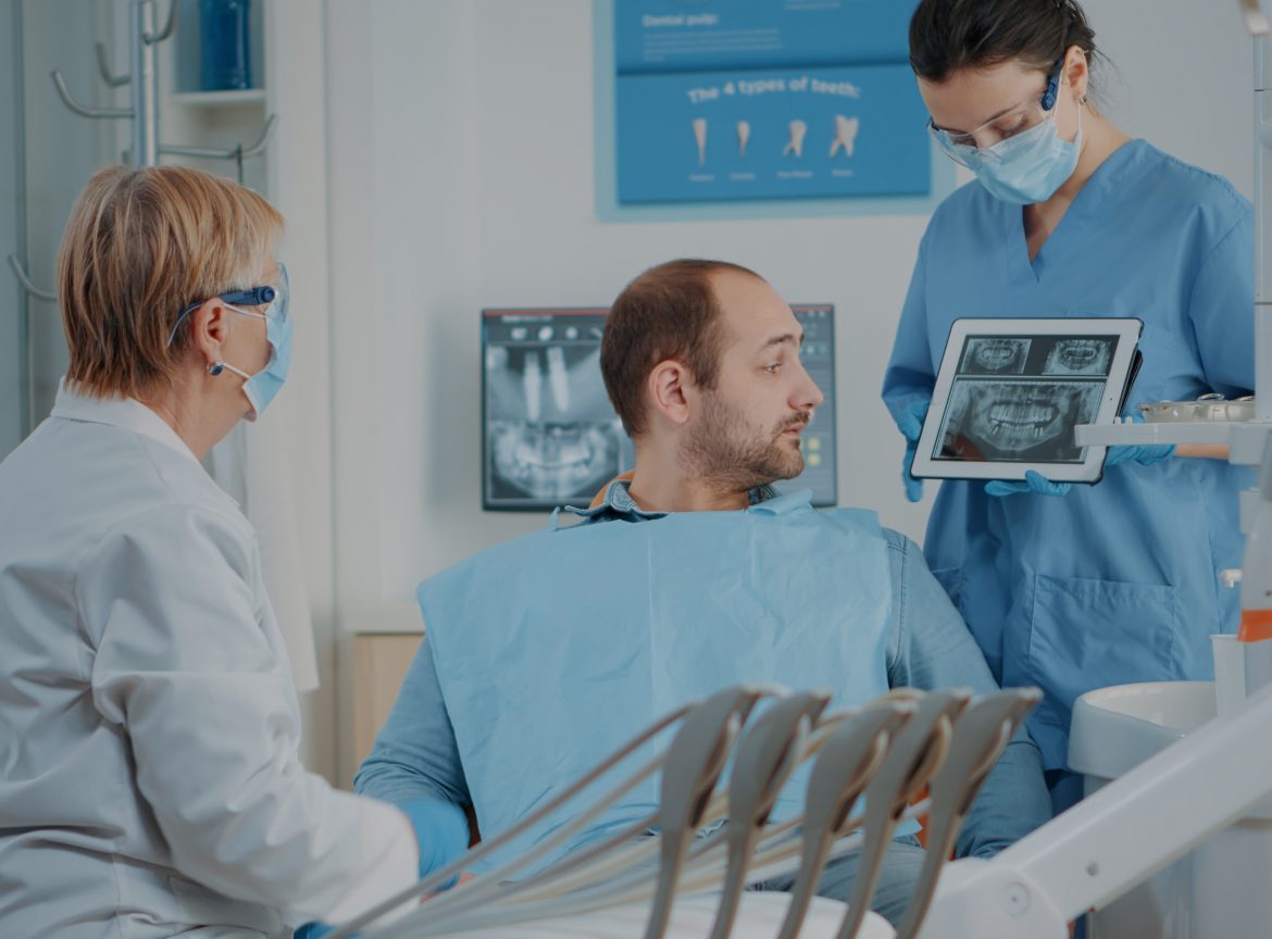Dentist reviewing X-ray results with a patient