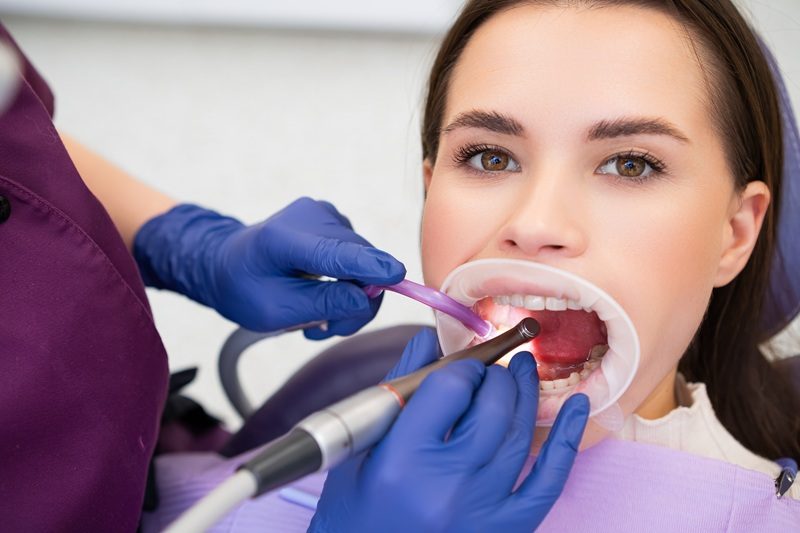 Dentist performing a deep cleaning treatment
