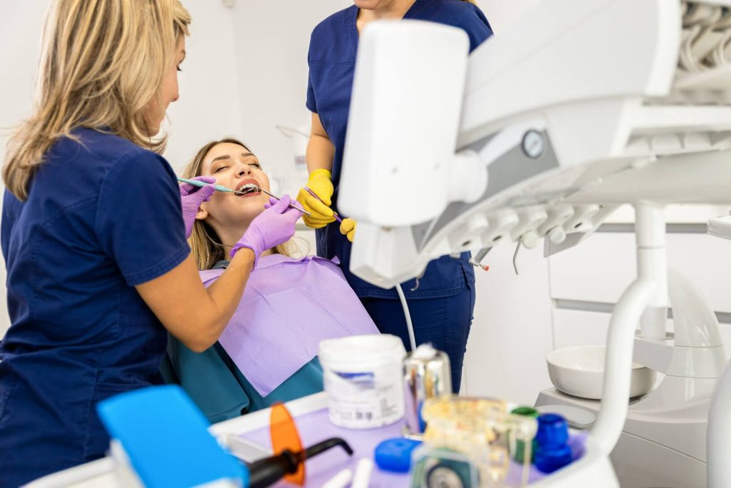 Dentist and assistant performing restorative treatment